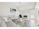 Bright living room features a cozy fireplace, hardwood floors, a leather couch, and plenty of natural light at 1925 Meyers Dr, Lawrenceville, GA 30045