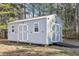 Backyard storage shed with double doors and ramp, offering convenient access and storage at 1925 Meyers Dr, Lawrenceville, GA 30045