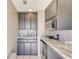 Convenient butler's pantry offering sleek gray cabinetry, granite countertops, sink, and microwave at 2277 Peachtree Ne Rd # 608, Atlanta, GA 30309