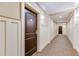 Well-lit hallway with paneled walls and carpeting leading to apartment door at 2277 Peachtree Ne Rd # 608, Atlanta, GA 30309