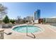 Relax in the inviting hot tub, perfect for unwinding with lounge chairs and manicured landscaping at 2277 Peachtree Ne Rd # 608, Atlanta, GA 30309