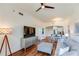 Spacious living room featuring hardwood floors, a ceiling fan, and an open view to the kitchen and dining area at 2277 Peachtree Ne Rd # 608, Atlanta, GA 30309