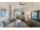 Bright living room featuring a cozy sofa, balcony access, hardwood floors, and stylish decor at 2277 Peachtree Ne Rd # 608, Atlanta, GA 30309