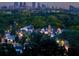 Scenic view of a city skyline at dusk, surrounded by lush green trees and charming residential areas at 3680 Tanglewood Se Dr, Atlanta, GA 30339