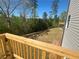 New backyard with a view of the surrounding trees from the deck at 630 Gilles Ln, Cumming, GA 30041