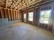 Unfinished basement with exposed beams, concrete walls, and windows at 630 Gilles Ln, Cumming, GA 30041