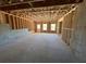 Unfinished basement with exposed beams and windows for natural light at 630 Gilles Ln, Cumming, GA 30041