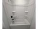 Clean, all-white bathtub with built in shelving at 630 Gilles Ln, Cumming, GA 30041