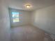 Bright bedroom featuring a window offering natural light at 630 Gilles Ln, Cumming, GA 30041