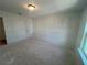 Bedroom features natural light and a door to the hallway at 630 Gilles Ln, Cumming, GA 30041