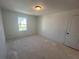 Bedroom featuring bright window and closet door at 630 Gilles Ln, Cumming, GA 30041