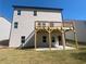 Exterior view showing back of home featuring a wooden deck, patio, and seeded lawn at 630 Gilles Ln, Cumming, GA 30041