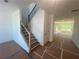 Hallway featuring a staircase and access to the main living area with large sunny windows at 630 Gilles Ln, Cumming, GA 30041