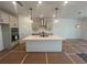 Well-lit kitchen featuring a large island, stainless steel appliances and modern fixtures at 630 Gilles Ln, Cumming, GA 30041