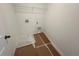 Practical laundry room equipped with a white wire shelf, washer/dryer hookups and tiled flooring at 630 Gilles Ln, Cumming, GA 30041