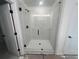 Beautiful glass-enclosed walk-in shower with marble-look tile surround at 630 Gilles Ln, Cumming, GA 30041