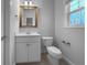 Well-lit bathroom features a vanity, toilet, and a window for natural light at 9585 Grande Dr, Winston, GA 30187