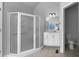 Bathroom featuring a tiled shower, vanity with mirror, and a toilet at 9585 Grande Dr, Winston, GA 30187