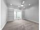Bedroom featuring neutral carpet, custom built in shelves and a view to the backyard at 9585 Grande Dr, Winston, GA 30187