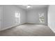 Bedroom featuring neutral carpet, base molding and large windows overlooking the yard at 9585 Grande Dr, Winston, GA 30187