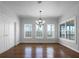 Bright dining room with hardwood floors, chandelier and natural light from large windows at 9585 Grande Dr, Winston, GA 30187
