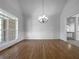Dining room with hardwood floors, chandelier, and large window at 9585 Grande Dr, Winston, GA 30187