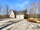 Home's exterior with spacious driveway, multi car garage and mature landscaping at 9585 Grande Dr, Winston, GA 30187