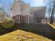 Charming two-story home boasting a large upper deck and a brick and siding exterior on a landscaped yard at 9585 Grande Dr, Winston, GA 30187