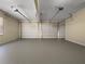 Three car garage with painted floor, and two automatic garage door openers at 9585 Grande Dr, Winston, GA 30187