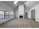 Open-concept living room with fireplace, skylights, and neutral carpet at 9585 Grande Dr, Winston, GA 30187