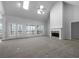 Expansive living room featuring fireplace, skylights, and access to outdoor space at 9585 Grande Dr, Winston, GA 30187