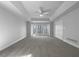 Spacious main bedroom with tray ceiling, carpet, large windows and closet at 9585 Grande Dr, Winston, GA 30187
