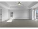 Spacious main bedroom featuring a tray ceiling, neutral carpet and lots of natural light at 9585 Grande Dr, Winston, GA 30187