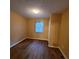 A small bedroom with wood floors, one window, and a single overhead light at 2061 Detroit Nw Ave, Atlanta, GA 30314