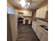 Traditional kitchen featuring a refrigerator, stove, white cabinets and countertops, and gray backsplash at 2061 Detroit Nw Ave, Atlanta, GA 30314