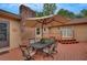 Backyard patio with a wooden deck, six chairs, and a table with an umbrella for shade at 12040 Old Mountain Park Rd, Roswell, GA 30075