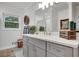 Bright bathroom featuring grey cabinets, white countertops, and modern fixtures at 12040 Old Mountain Park Rd, Roswell, GA 30075