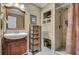 Bathroom features a wooden vanity and cabinet, along with a shower and tile flooring at 12040 Old Mountain Park Rd, Roswell, GA 30075