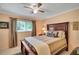 Bedroom featuring a large bed, wood furniture, and a window with natural light at 12040 Old Mountain Park Rd, Roswell, GA 30075