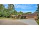 Charming single-story home boasts a lush, landscaped yard and a spacious driveway leading to an attached garage at 12040 Old Mountain Park Rd, Roswell, GA 30075