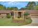 A well-maintained house with a manicured lawn, pergola and attached garage at 12040 Old Mountain Park Rd, Roswell, GA 30075