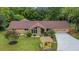 Landscaped home with mature trees and a meticulously maintained lawn and pergola at 12040 Old Mountain Park Rd, Roswell, GA 30075