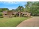 Charming front yard with lush green grass, trees, and a stone and wooden pergola at 12040 Old Mountain Park Rd, Roswell, GA 30075