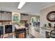 Open kitchen with tile floor, island, white cabinets, and granite counters at 12040 Old Mountain Park Rd, Roswell, GA 30075