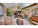 Comfortable living room with cozy seating, a piano, and an open floor plan at 12040 Old Mountain Park Rd, Roswell, GA 30075
