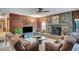 Cozy living room with a stone fireplace, wood paneled walls, and comfortable seating at 12040 Old Mountain Park Rd, Roswell, GA 30075