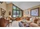 Elegant living room featuring large windows, comfortable seating, and a classic piano at 12040 Old Mountain Park Rd, Roswell, GA 30075