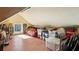 Attic storage space with wood-look flooring, a small window, and storage boxes at 1325 Whitlock Sw Ave, Marietta, GA 30064