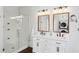 Bright bathroom featuring double vanity, modern fixtures, and glass-enclosed shower at 1325 Whitlock Sw Ave, Marietta, GA 30064