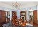 Traditional dining room with chandelier, fireplace, hardwood floors and blue accent wall at 1325 Whitlock Sw Ave, Marietta, GA 30064